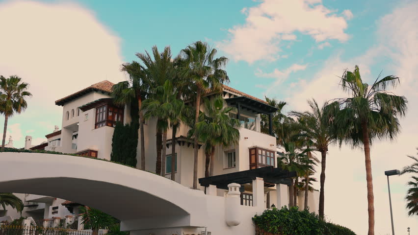 Villa Is Surrounded By Exotic Plants. Exotic Nature Of Spain. Villa On Background Of Sky.