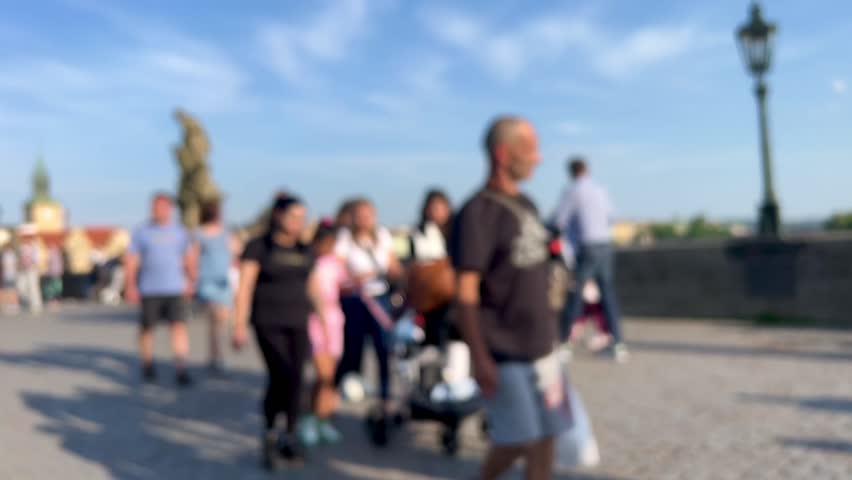 blurred background with people walking in the street of old town in prague, czech republic. people or tourists walking in the city. blurred or blurry background of prague city 