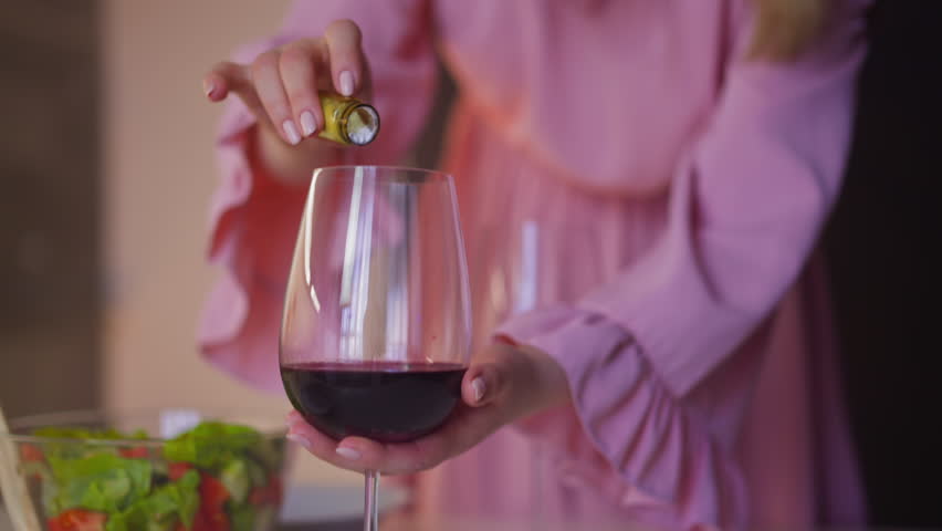 Faithless wife adds venom white powder into annoying husband wineglass and stirs red wine to kill and get freedom at home slow motion closeup Royalty-Free Stock Footage #1104129921