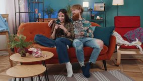 Planning family budget. Smiling family married couple man woman counting money cash, use smartphone calculate domestic bills at home. Husband wife satisfied of income for planned vacation, gifts - Powered by Shutterstock - Get 15% off with code: PIKWIZARD15