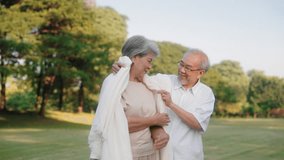Asian senior couple give blanket and embracing in public park, Take care concept - Powered by Shutterstock - Get 15% off with code: PIKWIZARD15