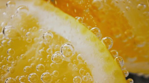 Bubbly Lemon Drink with Natural Fruit in Shiny Glass Close-up. Fresh Alcohol Cocktail or Sour Vegan Lemonade for Party. Fizzy Mineral Water with Running Gas and Citron as Healthy Beverage in Home Menu : vidéo de stock