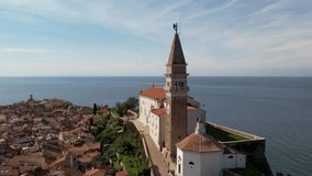 City of piran in slovenia with shot of church and sea
