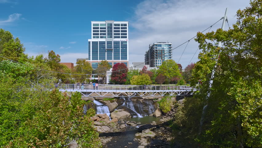 Aerial view of Reedy River Waterfalls in downtown of Greenville city in South Carolina. Falls Park riverwalk at Liberty bridge. American travel destination