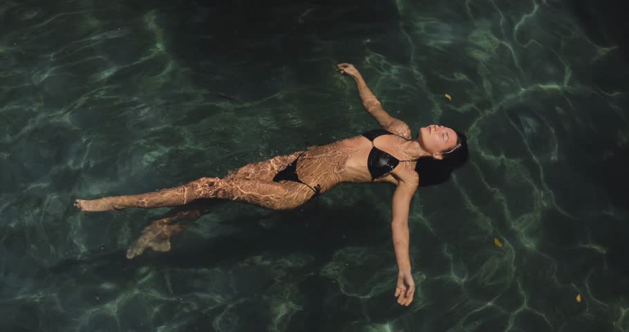 Tanned Asian Model in Black Bikini in Swimming Pool Spa