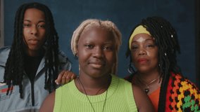 Two lesbian women and non binary friend against studio backdrop - Powered by Shutterstock - Get 15% off with code: PIKWIZARD15