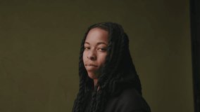 Non binary person with braids looking at camera ageist studio backdrop - Powered by Shutterstock - Get 15% off with code: PIKWIZARD15