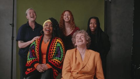 Five LGBTQIA queer people smiling and laughing against studio backdrop 庫存影片