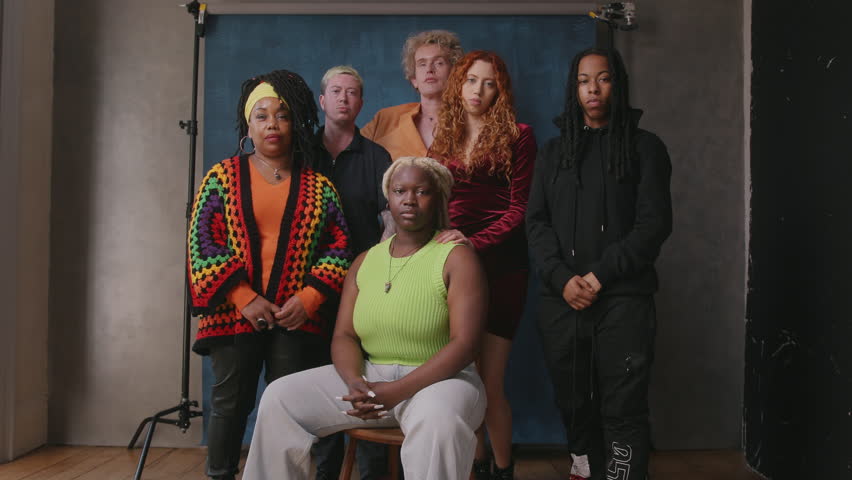 Handheld shot of six LGBTQIA queer people facing camera against studio backdrop | Shutterstock HD Video #1104148075