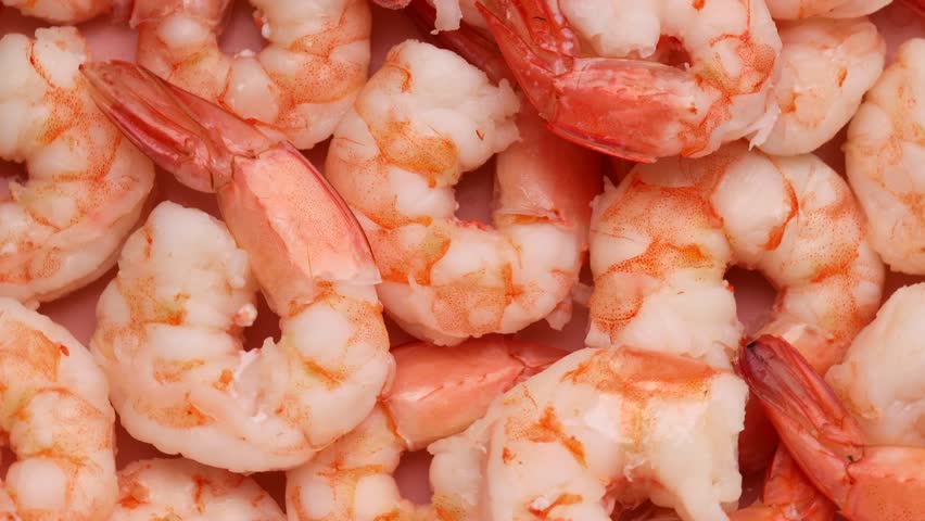 Pink frozen shrimp with ice, rotation in circle. fish background, Turning. selective focus. cooked seafood Royalty-Free Stock Footage #1104152281