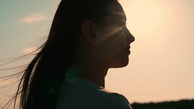 Portrait of girl, sun day, silhouette. Beautiful flowing female brown hair. Young woman looks at sky, prays, religious man. Girl hair flutters in wind, they believe in goodness, women dream of love. - Powered by Shutterstock - Get 15% off with code: PIKWIZARD15
