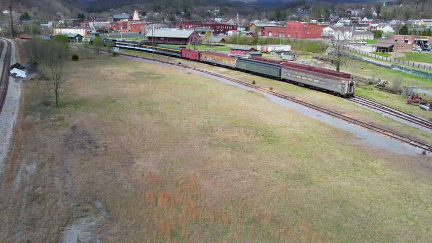 Clifton forge, virginia - circa 2023 - excellent aerial view moving from a halted freight train, over town towards the mountains.