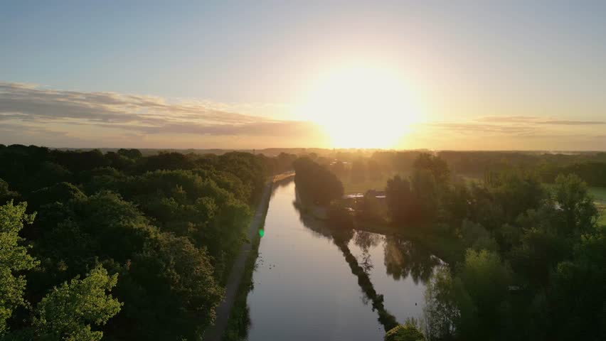 Beautiful sunset over a river with green bushes and color rich sky. High quality photo
