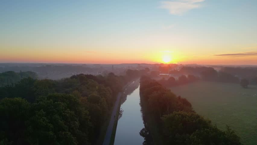 Beautiful sunset over a river with green bushes and color rich sky. High quality photo