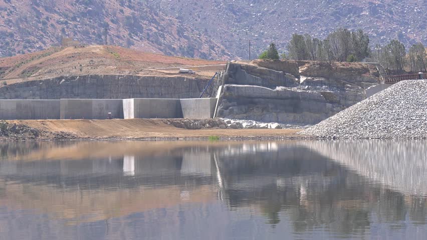 2023 Isabella Lake dam, reservoir during high water levels, Spring runoff, smooth water, Sierra Nevada Mountains. Labyrinth Weir emergency spillway.  Royalty-Free Stock Footage #1104169575
