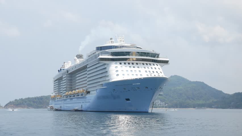 Giant cruise ship docked in the middle of ocean of Patong sea at Phuket under sunny day vacation holiday time. Luxuary Cruise ship tender in the sea in thailand Royalty-Free Stock Footage #1104173791