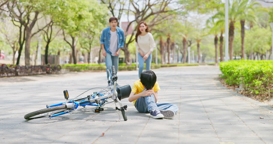 asian parents educate child ride bicycle - kid fall down injured cry father and mother run to comfort him Royalty-Free Stock Footage #1104177481
