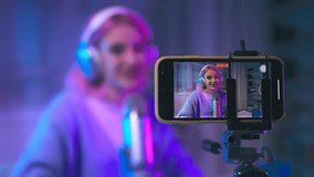 Young creative woman using phone to record a video for social media, influencer