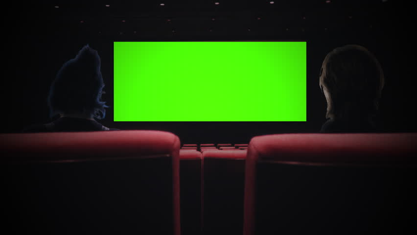 Cinema Couple Green Screen Watching Movie Theater Zoom In. Couple inside a movie theater watching a green screen projection, zoom in. Royalty-Free Stock Footage #1104186465