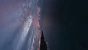 Vertical video. Tropical island sea beach night panorama cloudy sky horizon aerial view. FPV sport drone raising up altitude shot exotic scenery seashore coastline ocean evening dark sunset sunrise 4k
