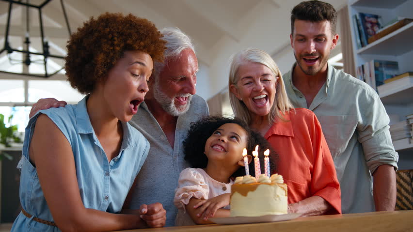 Multi-generation family celebrate granddaughter's birthday at home with cake singing Happy Birthday song - shot in slow motion Royalty-Free Stock Footage #1104188037