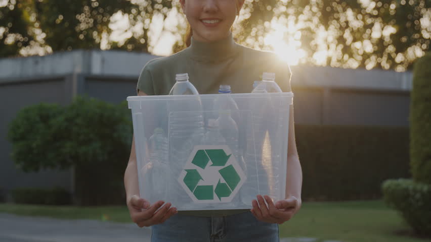 Save the planet reduce CO2 go green people carry bin box at outdoor nature, reuse recycle clean sort waste symbol. Global Earth protect day hope for future net zero eco friendly happy woman lifestyle.