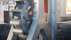 Footage of Metal water turbine slow spinning to generate free and green electricity