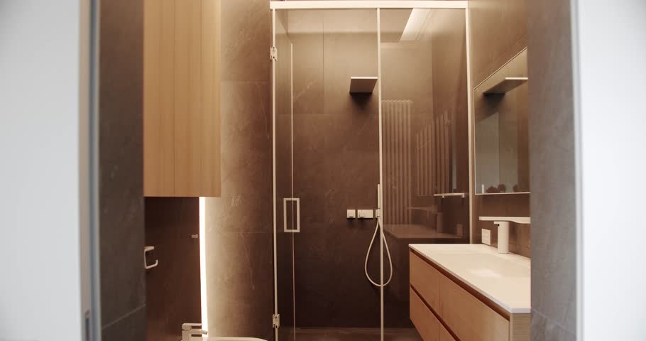 Mirror and shower head, bathtub modern design. Luxury cozy white Apartment. Luxury Bathroom Interior, Minimalist interior in brown colors with bathroom accessories. Bathroom with simplicity design. Royalty-Free Stock Footage #1104189859