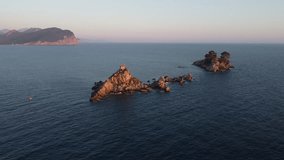 4k video. Shooting from a drone. Montenegro. Petrovac. Sunset over the islands of St. Resurrection and Katic. 100 meters high. 