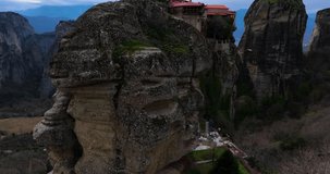 drone video of meteora monasteries from above bird view with cloudy sky greece polichni 4k footage high quality