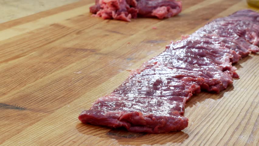 Detail of Butcher finishes Raw Skirt Steak for the barbecue Royalty-Free Stock Footage #1104206189