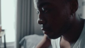 Young black basketball player sitting in his bedroom, touching ball with forehead, getting nervous before a game and trying to focus. Close-up shot, selective focus - Powered by Shutterstock - Get 15% off with code: PIKWIZARD15