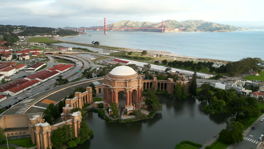 Beautiful morning arial footage around Palace of Fine Arts with cinematic sunrise and Golden Gate Bridge on background in the Bay Area 4K Hi Quality drone footage Royalty-Free Stock Footage #1104211715