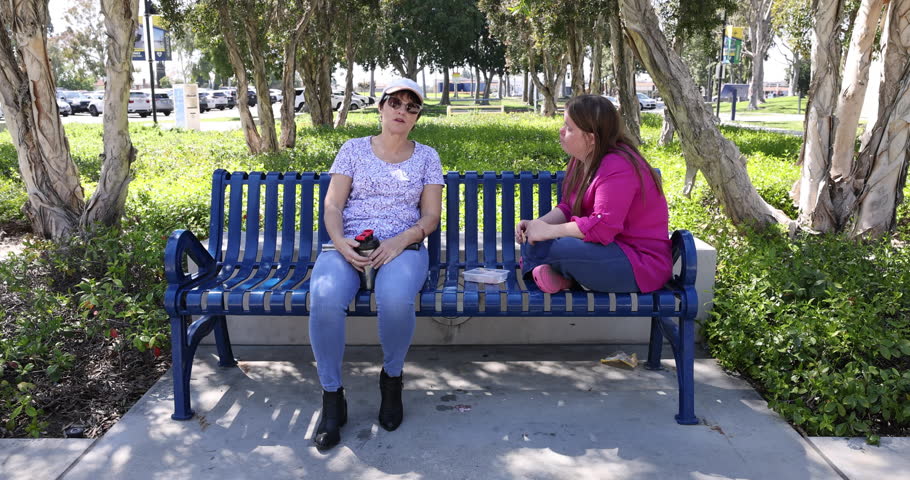 A blind woman telling a story to Down syndrome women while she eating lunch