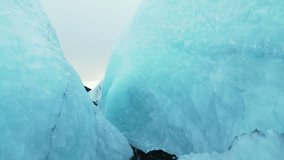 Drone shot of vatnajokull glacier cracks and crevasses with diamond frosty ice blocks, icelandic nature. Beautiful icebergs caves and frozen lake, nordic landscape. Close up. 60 fps video.