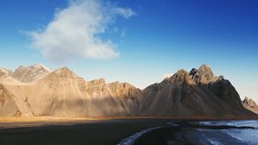 Drone shot of vestrahorn mountains in iceland, stokksnes beach peninsula creating majestic icelandic scenery. Beautiful nordic landscape with black sand beach, scenic route. 60 fps video.