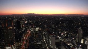 TOKYO, JAPAN : Aerial high angle sunset or sunrise view of CITYSCAPE of TOKYO and MOUNT FUJI. Shot from Shibuya station. Japanese urban city life, travel and nature concept 4K video.