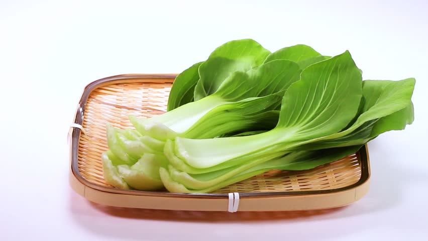 Bok choy vegetable on a bamboo colander on  white background rotating Royalty-Free Stock Footage #1104221863