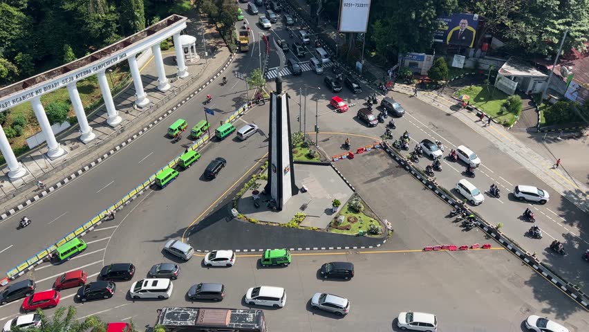 Bogor , West Java , Indonesia - 04 22 2023: Traffic jam at Tugu Kujang Monument at the heart of Bogor City