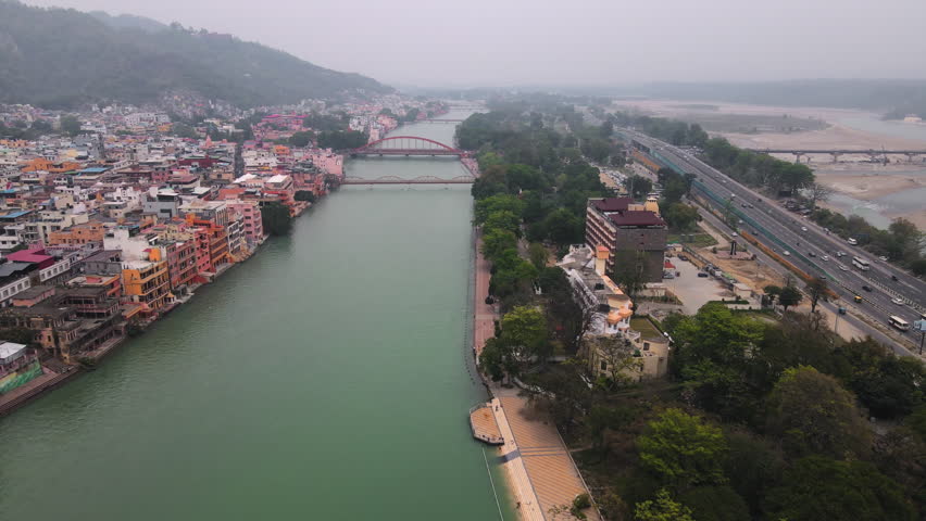 Aerial view of the Holy City Haridwar in Uttarakhand situated on the banks of the holy River Ganga. Developing India concept. Showing a great way to explore India via the well-developed Road Network. Royalty-Free Stock Footage #1104224849