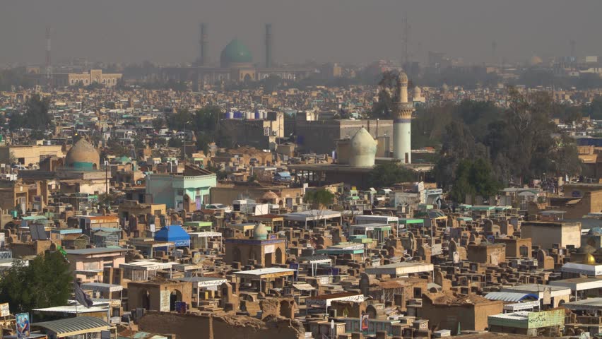Huge graveyard of Wadi-al-Salaam Islamic cemetery and mosque in background, Najaf in Iraq. Panoramic view Royalty-Free Stock Footage #1104229429