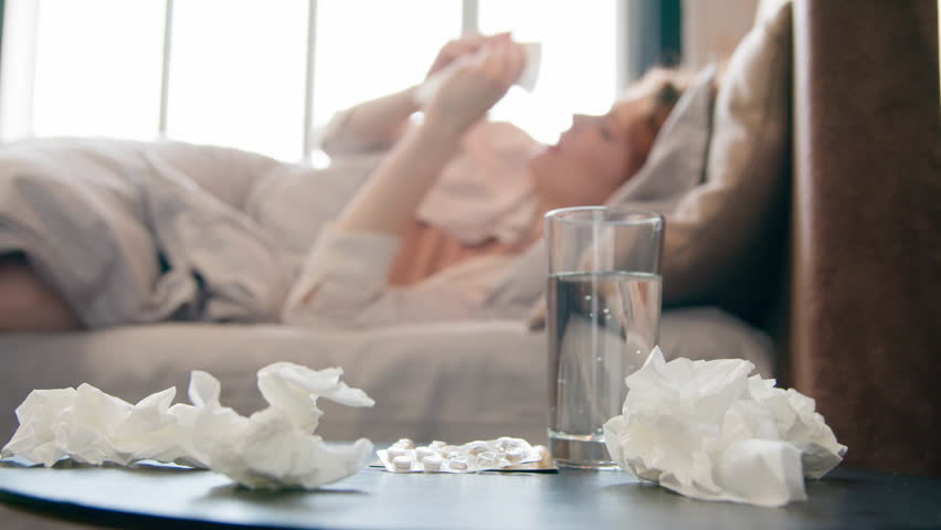 Unhealthy sick ill Caucasian woman sneeze in bed at home bad feeling coronavirus cold flu disease girl suffer headache fever seasonal virus allergy blowing runny nose in tissue napkin health problem Royalty-Free Stock Footage #1104231467