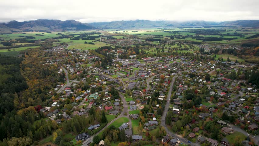 Small village surrounded by mountain range. Aerial wide urban landcape. Hanmer Springs, New Zealand