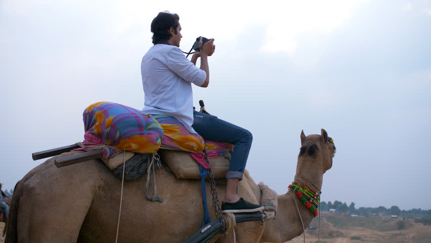 Indian boy sitting on camel