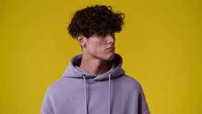 4k video of one man posing for a video on yellow background.