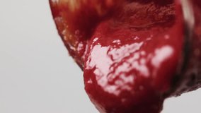 4K slow motion detail of red fresh ketchup which is poured from a transparent glass bottle, jar. - Powered by Shutterstock - Get 15% off with code: PIKWIZARD15