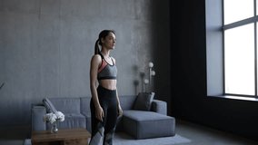 Young fitness woman make sits up exercises at home