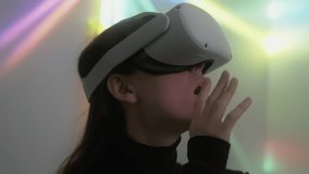 Young woman explores cyber space using vr headset and touches unreal objects. Portrait of female gamer enjoying playing virtual reality game admiring beauty of digital 3D environment