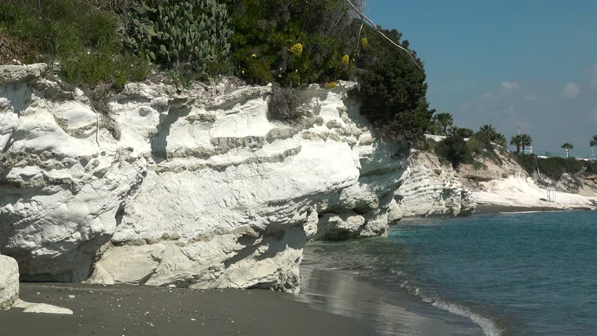 Picturesque seashore. Nature. Beautiful beach. Turquoise sea water and rocky shore. Panoramic view ocean waves washing stone coastline with foam. Cinematic marine landscape summer day. Seascape beauty