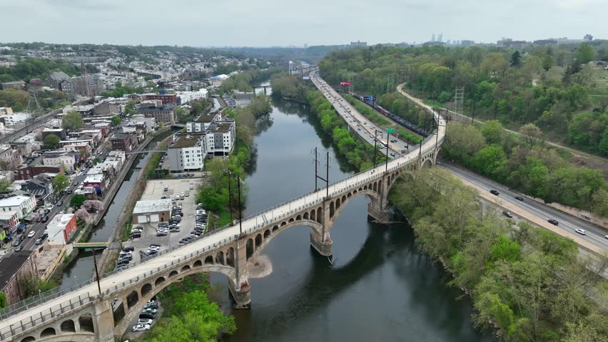 Aerial orbit around Manayunk bridge for pedestrians. USA small town outside of large city, Philadelphia.